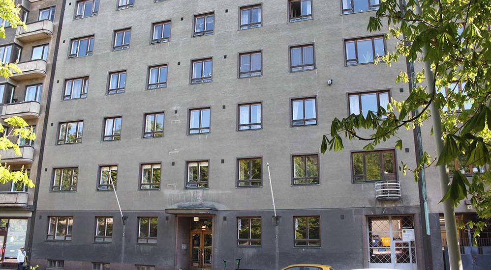 Foto av fasaden på Hesperiagatans flervåningshus. Huset har sex våningar och är grått.