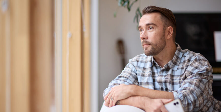 A man is looking out of the window.
