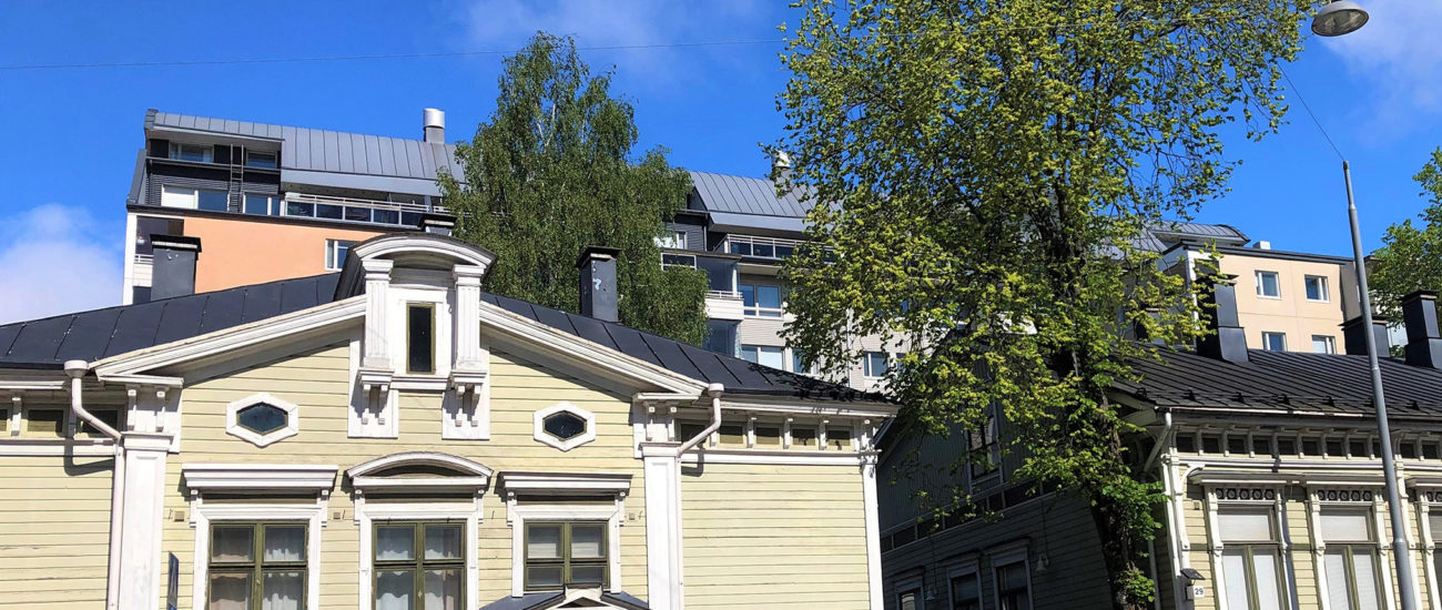 Fasaden på Slottsgatans bostadshus. Höghuset är längre bak. Den gröna trähuset är längst fram och mellan tränhusen är en port, genom vilken går man till bakgården. det är möjligt att parkera framför huset.